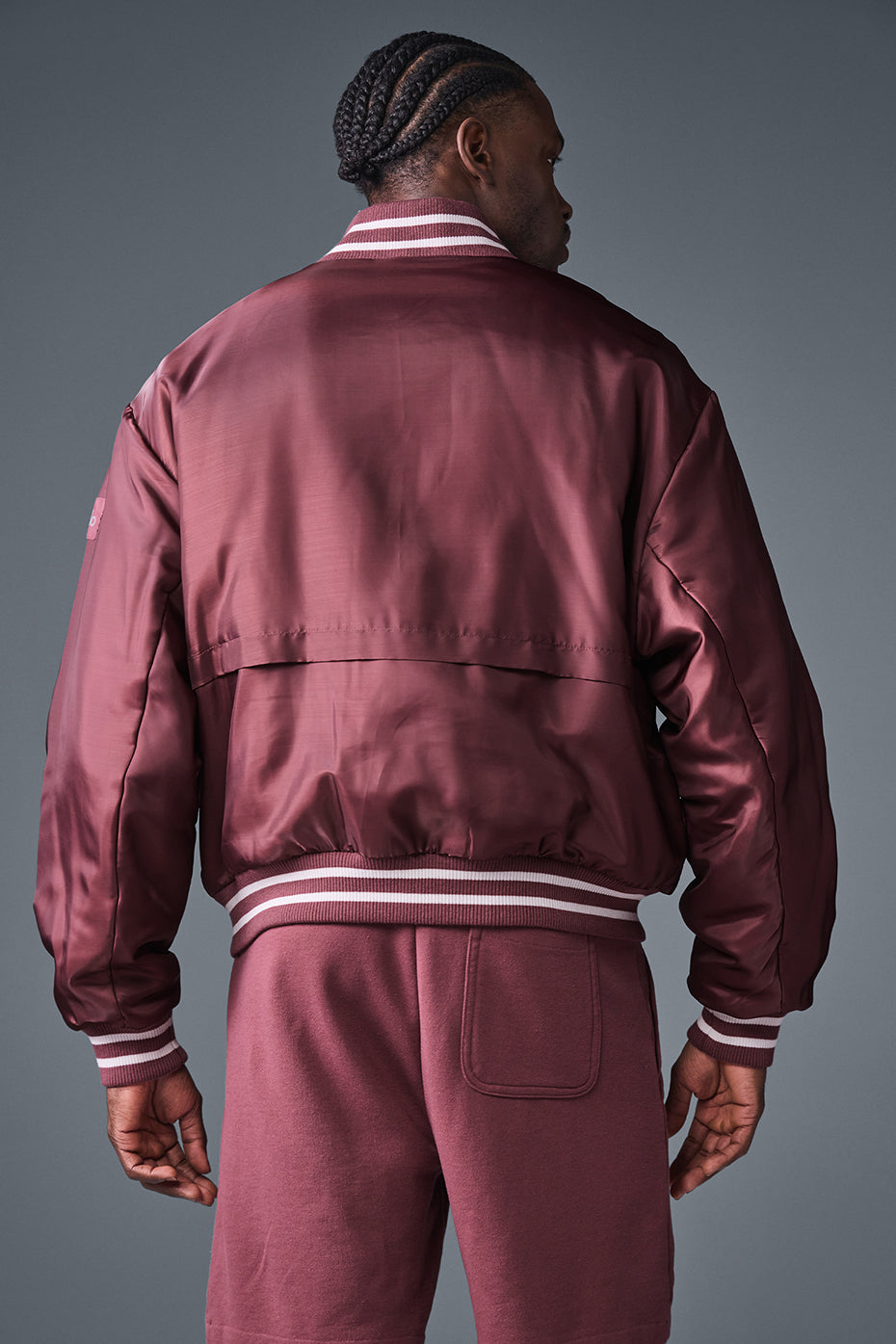 Back view of the burgundy bomber jacket highlighting its classic varsity style.