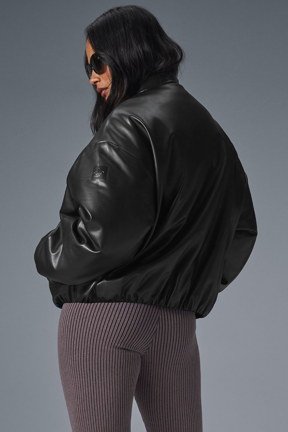 Front view of the luxe faux leather bomber jacket for women, showcasing its smooth texture.