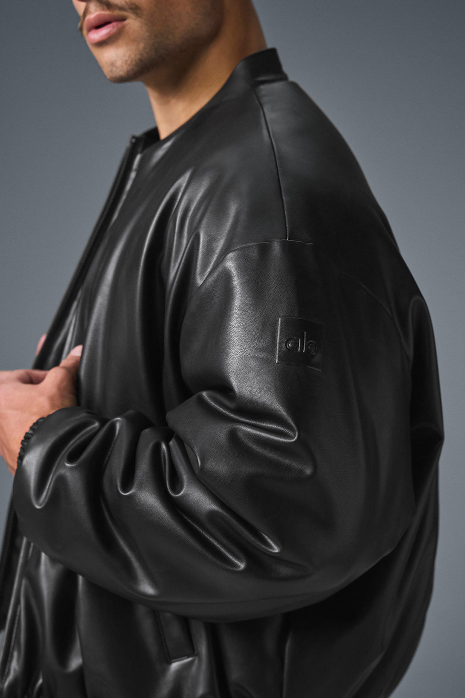 Model wearing the womens bomber jacket over a cozy knit sweater.