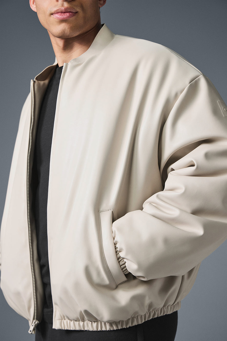 Front view of the faux leather bomber jacket, ideal for stylish outings.