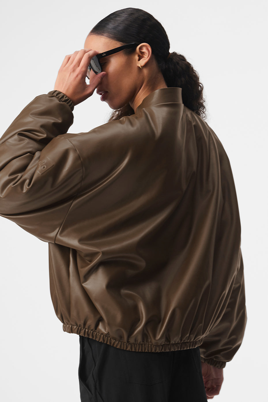 Model showcasing the faux bomber leather jacket, styled elegantly.