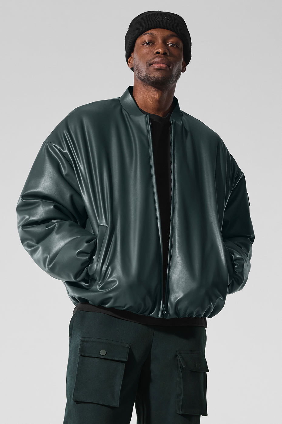 Front view of charcoal green bomber jacket styled with dark denim, ideal for streetwear looks.