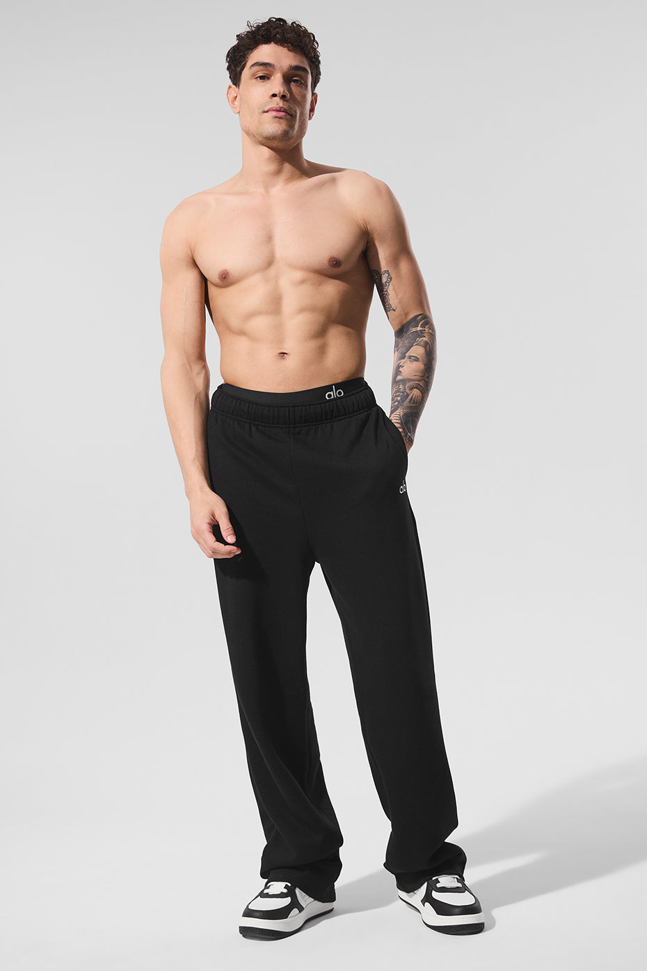 Back view highlighting chrome logo and fabric texture on comfortable pants