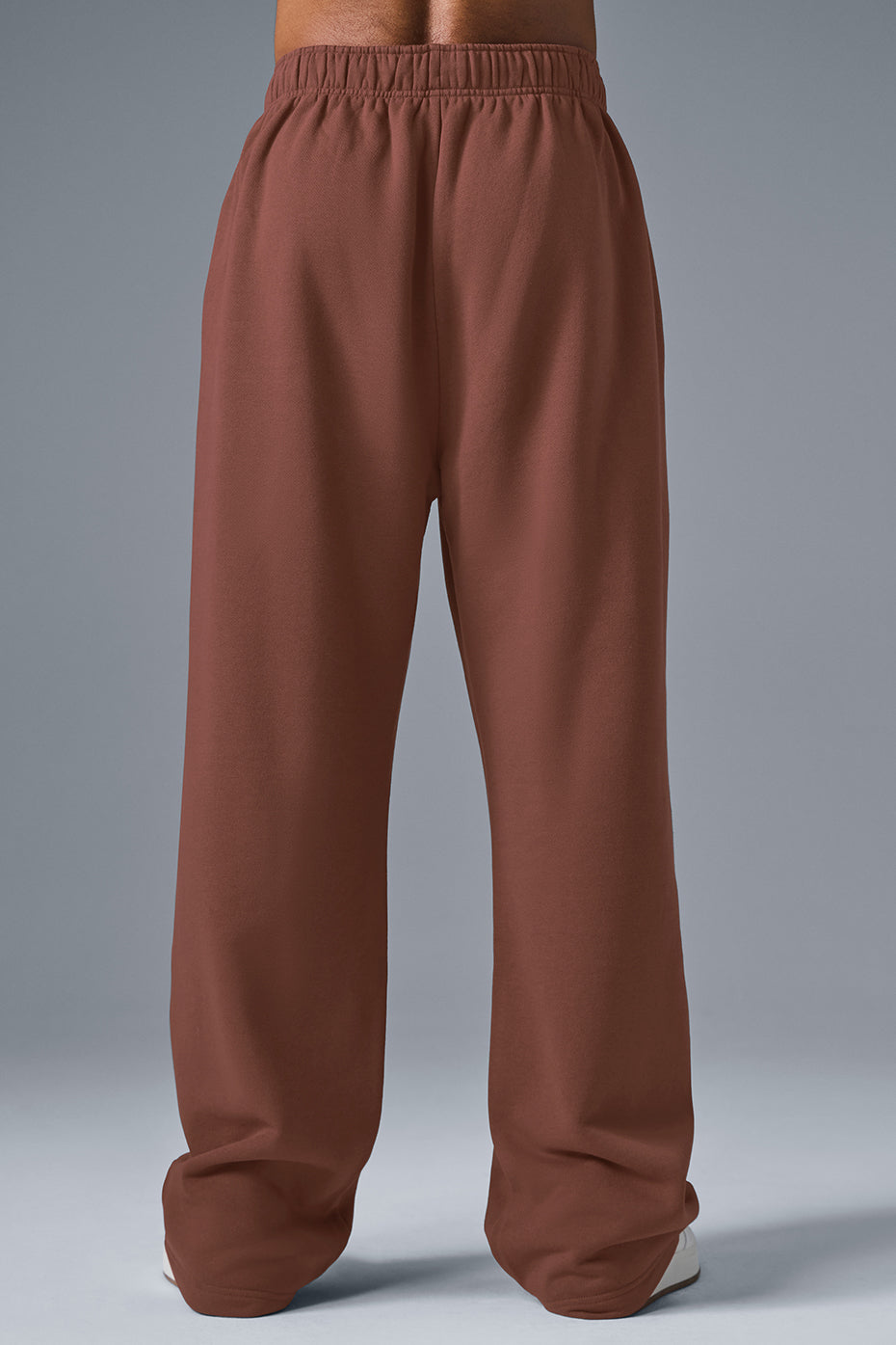 Close-up of the chrome ALO logo on Accolade Straight-Leg Sweatpants.