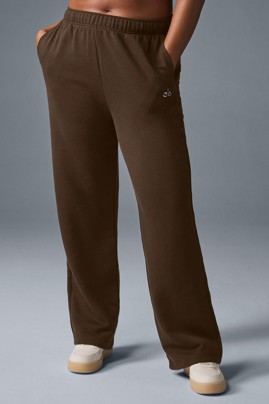 Close-up of grey sweatpants showing the Chrome ALO logo detail