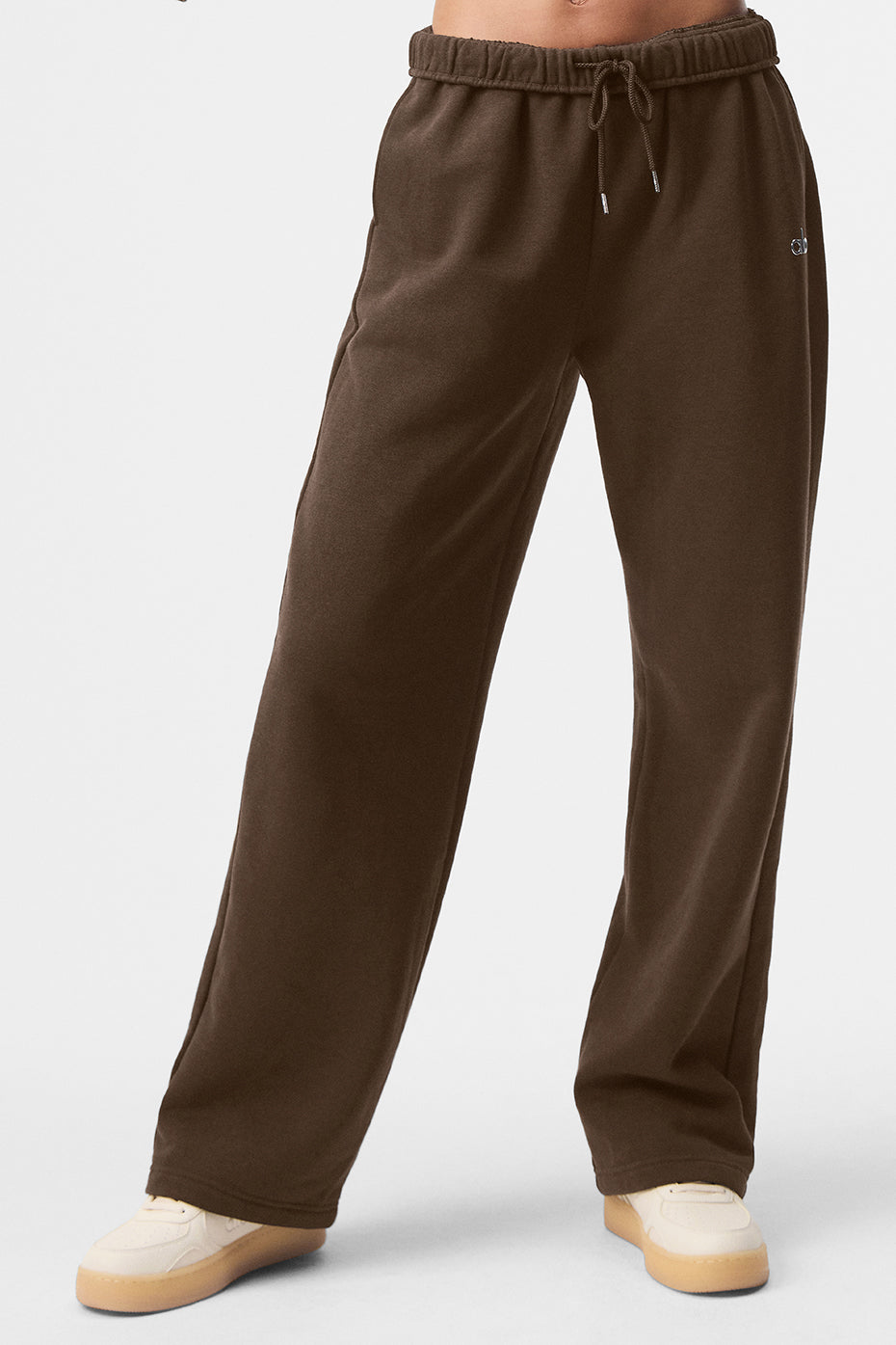 Men wearing wide leg sweatpants with a casual jacket in an outdoor urban setting