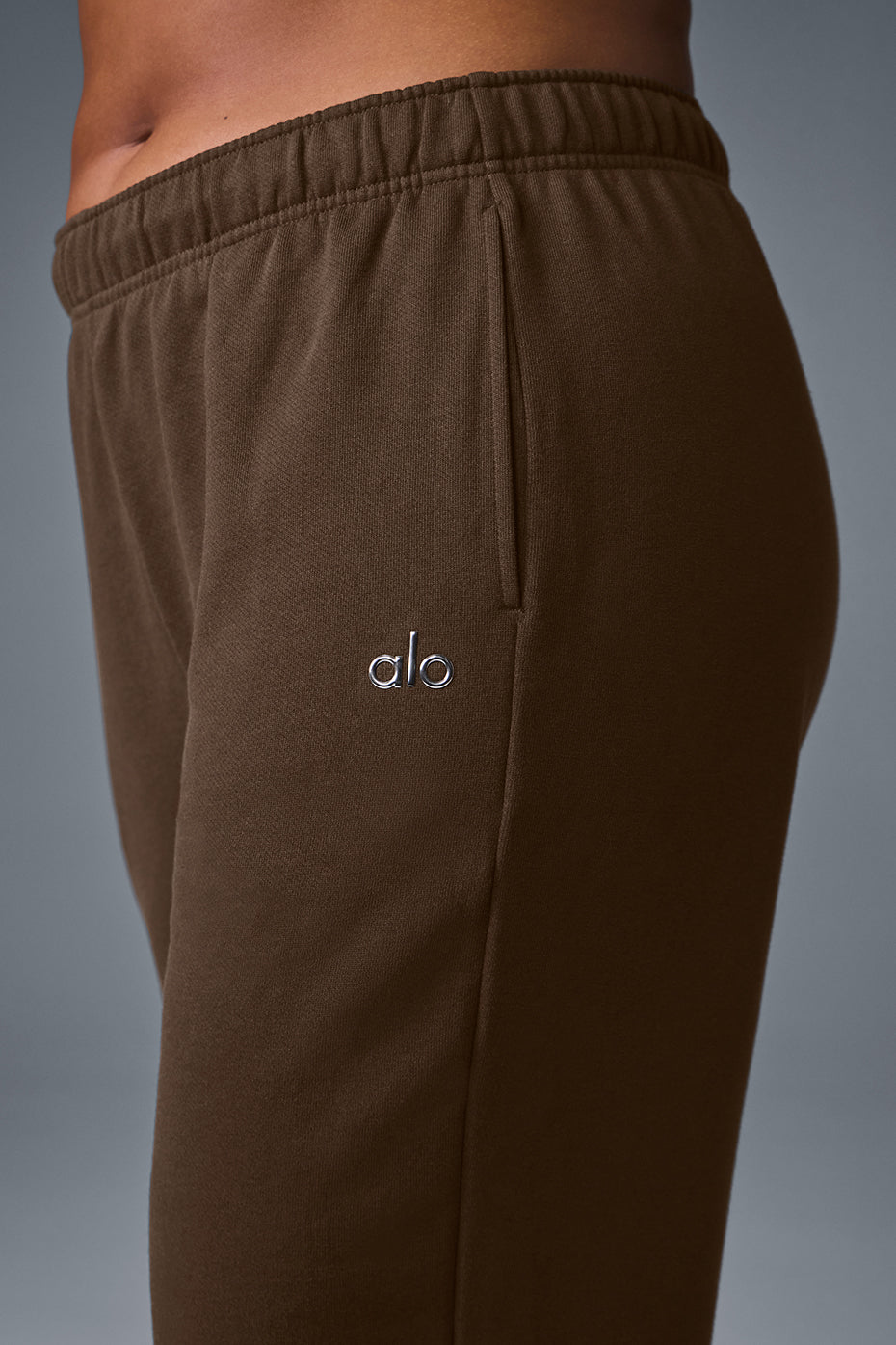 Men wearing wide leg sweatpants with a casual jacket in an outdoor urban setting