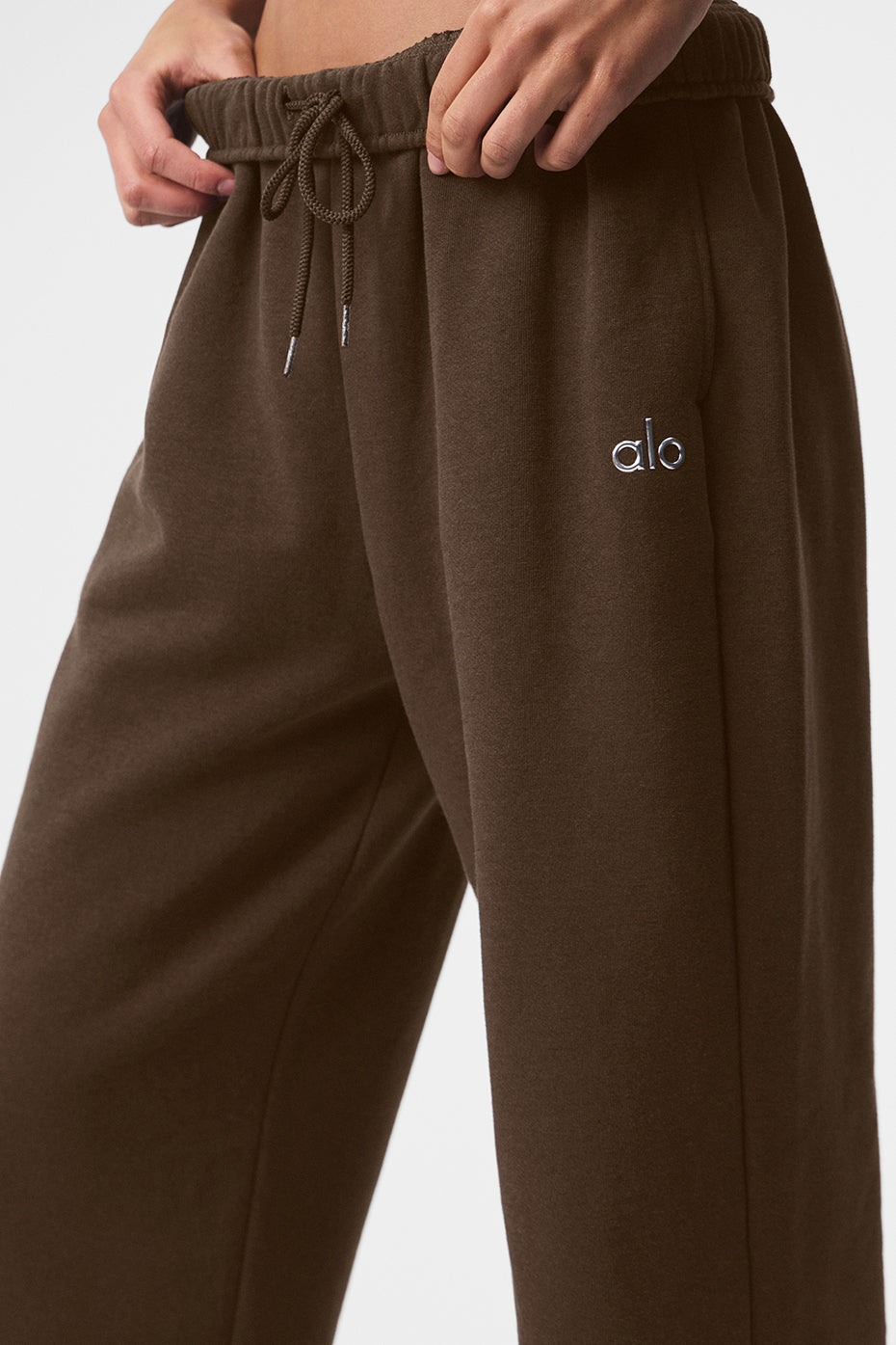 Model in athletic wear styled with slides for a relaxed street look