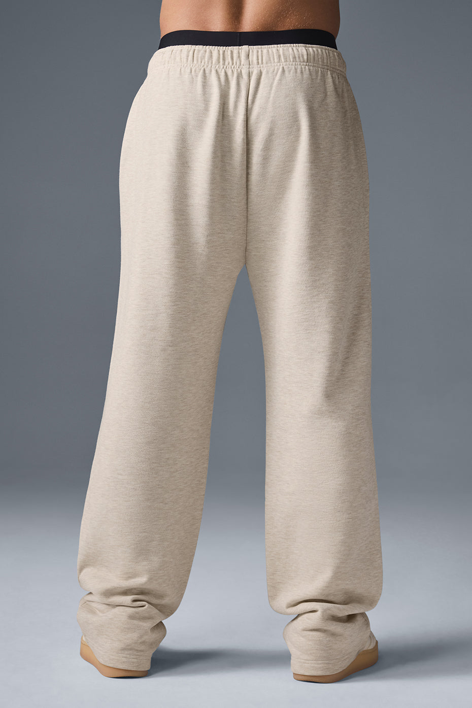 Side view showcasing the baggy fit of the oatmeal heather sweatpants.