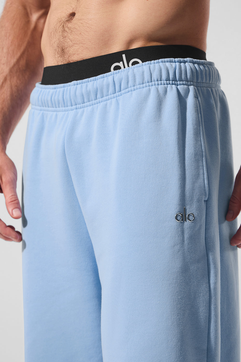 Side view showcasing the fit of the grey sweatpants.