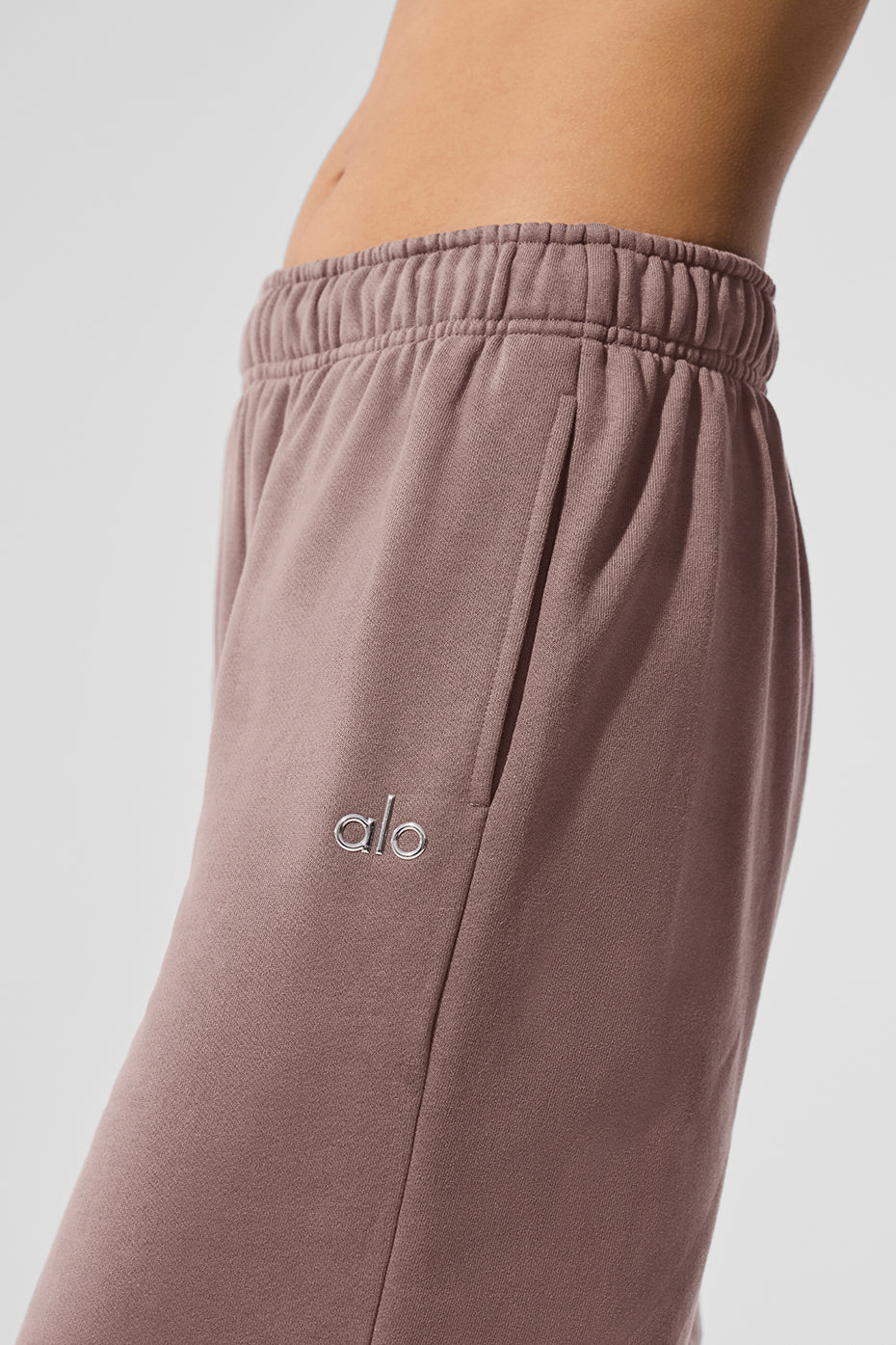Front view of Accolade performance sweatpants in mushroom color, showcasing the chrome logo.