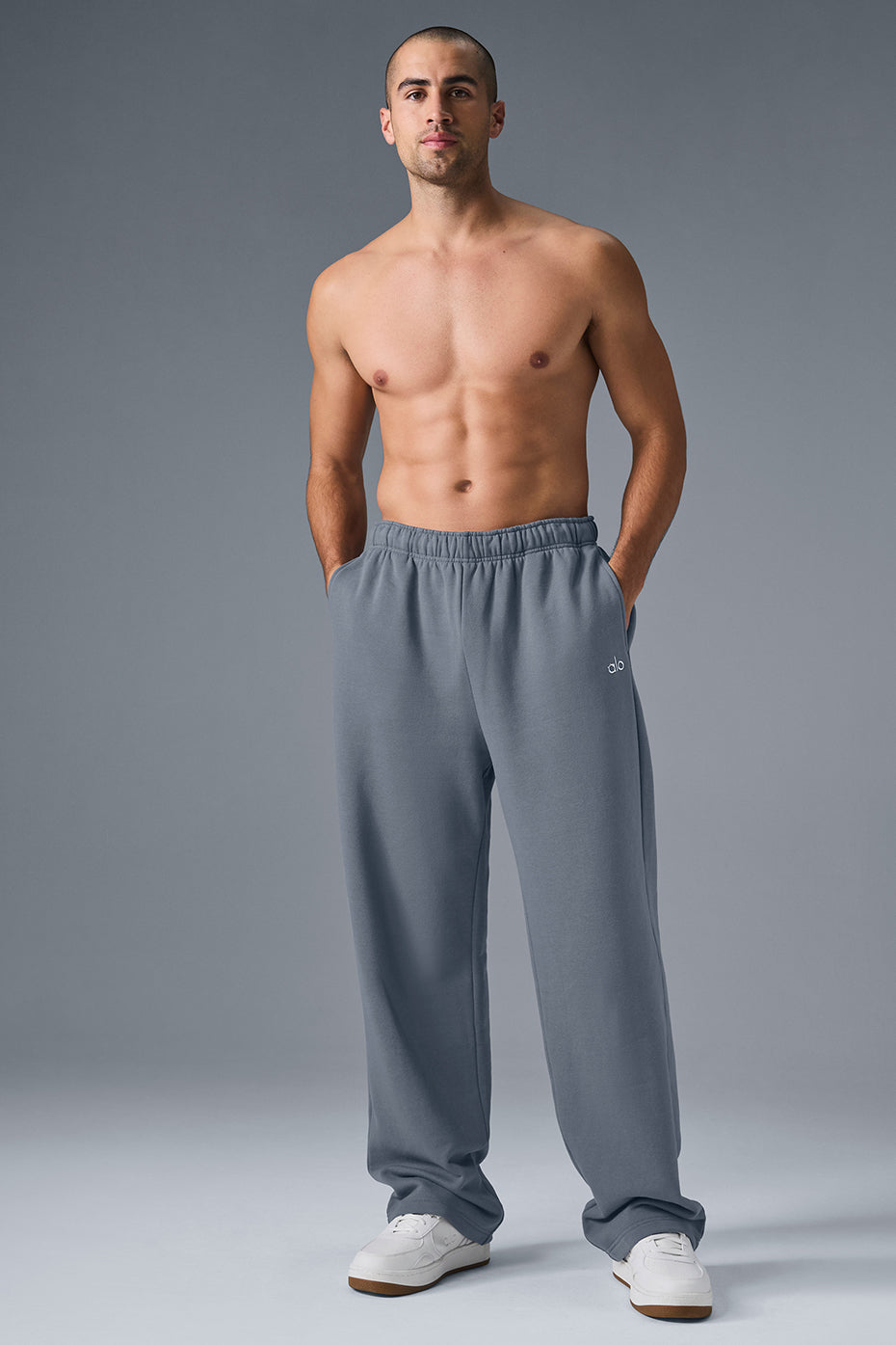 Back angle of baggy sweatpants showing relaxed fit and chrome logo