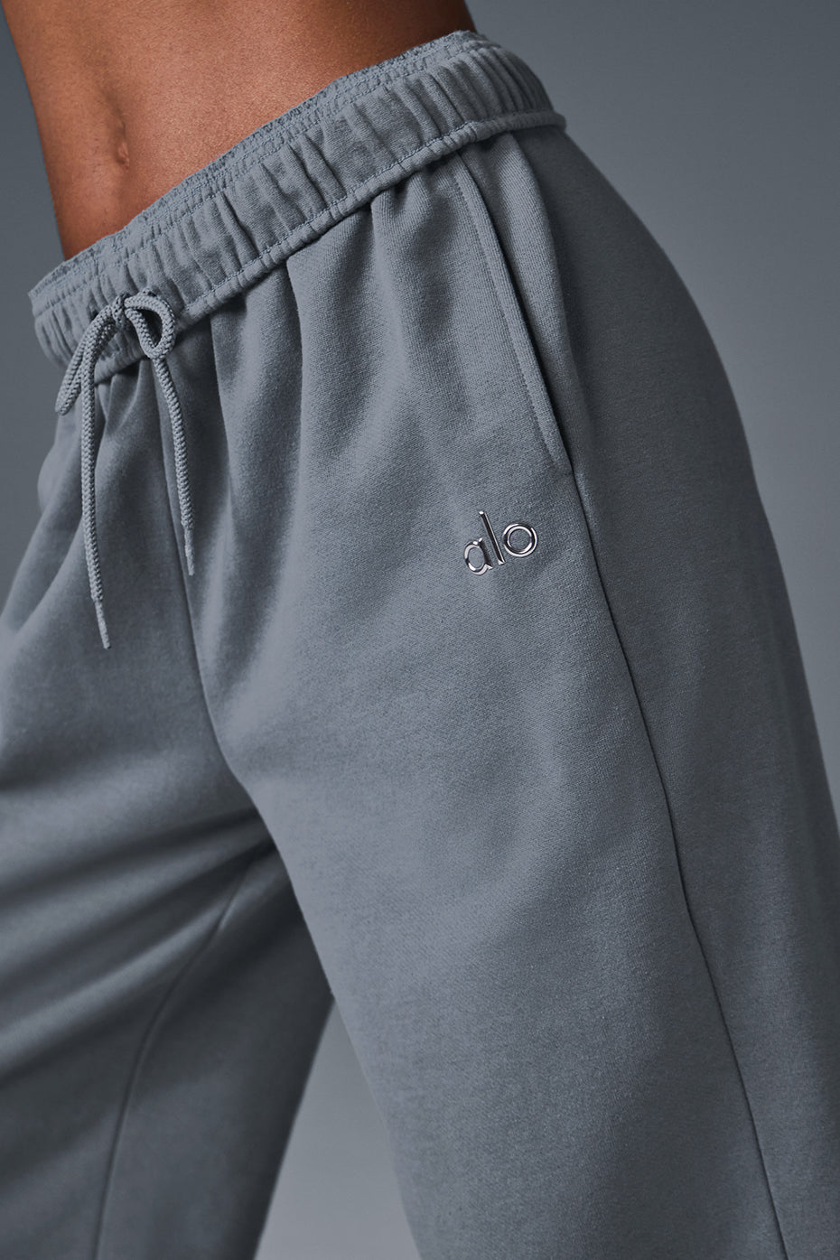 Model wearing Accolade straight-leg sweatpants styled with a bold jacket.