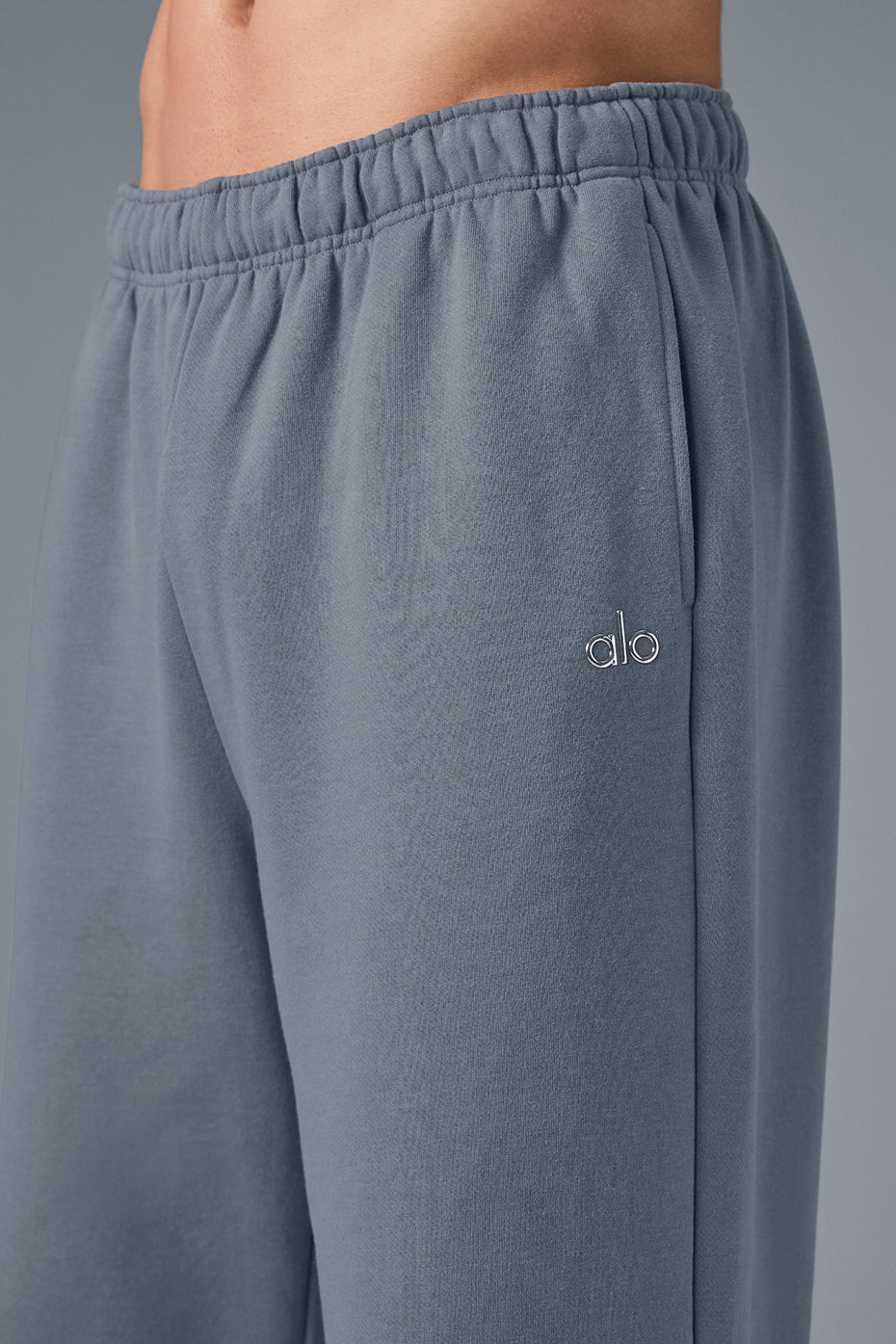 Front view of steel grey wide leg sweatpants styled with sneakers