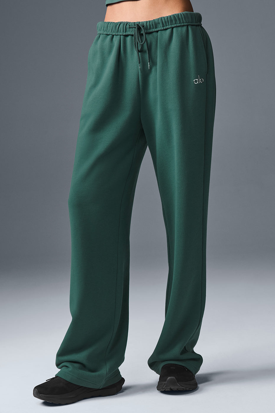 Front view of grey sweatpants with alo yoga logo in cold NYC setting