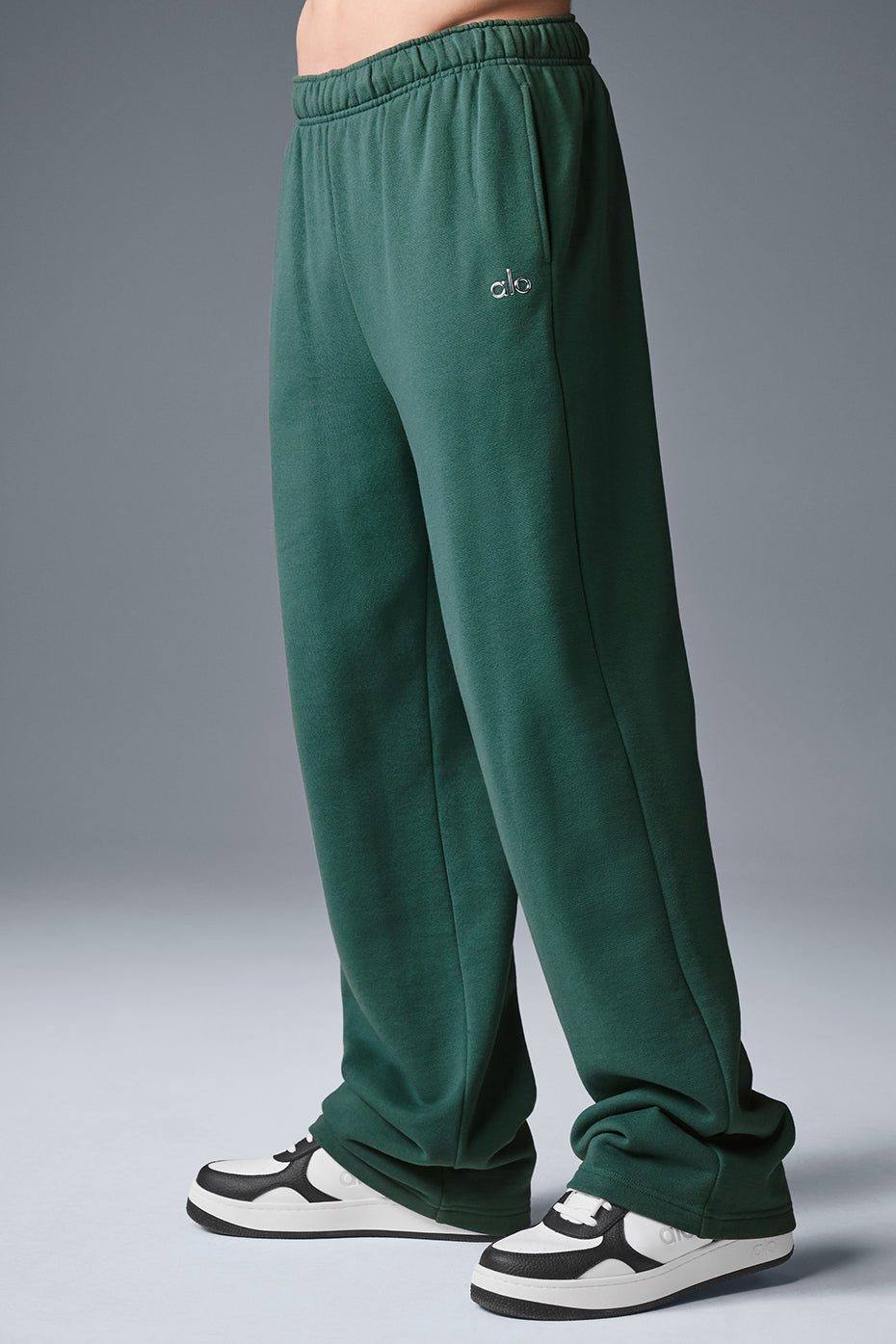 Model wearing camo sweatpants styled with a bold jacket for a trendy look.