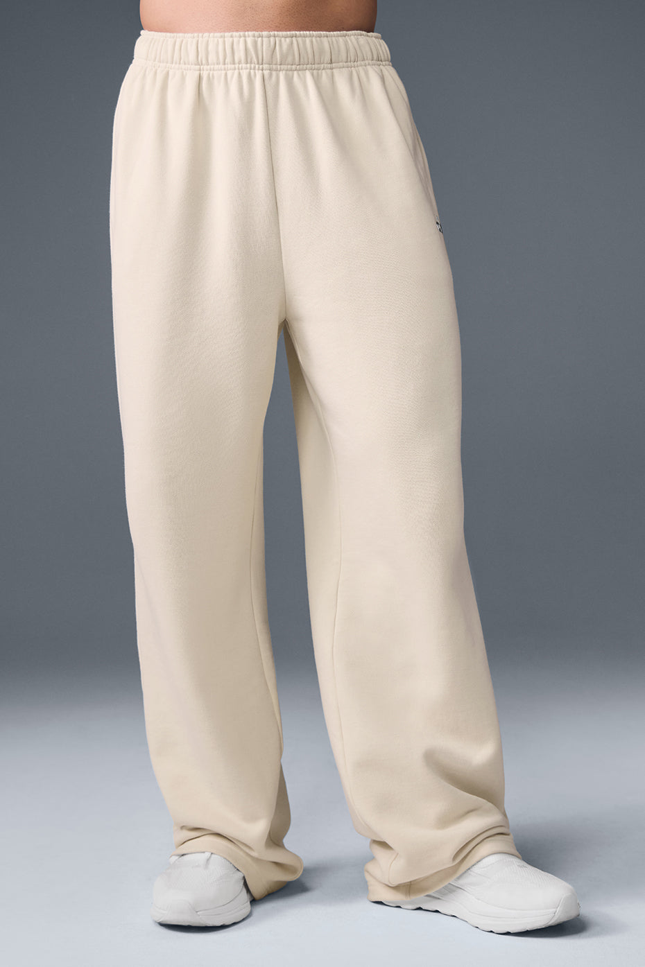 Front view of Accolade straight leg sweatpants in Oat Milk, showcasing the chrome logo.