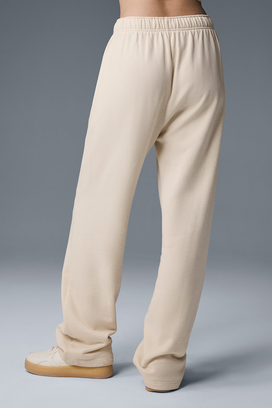 Styled image of the sweatpants paired with a jacket and sneakers for casual outings.