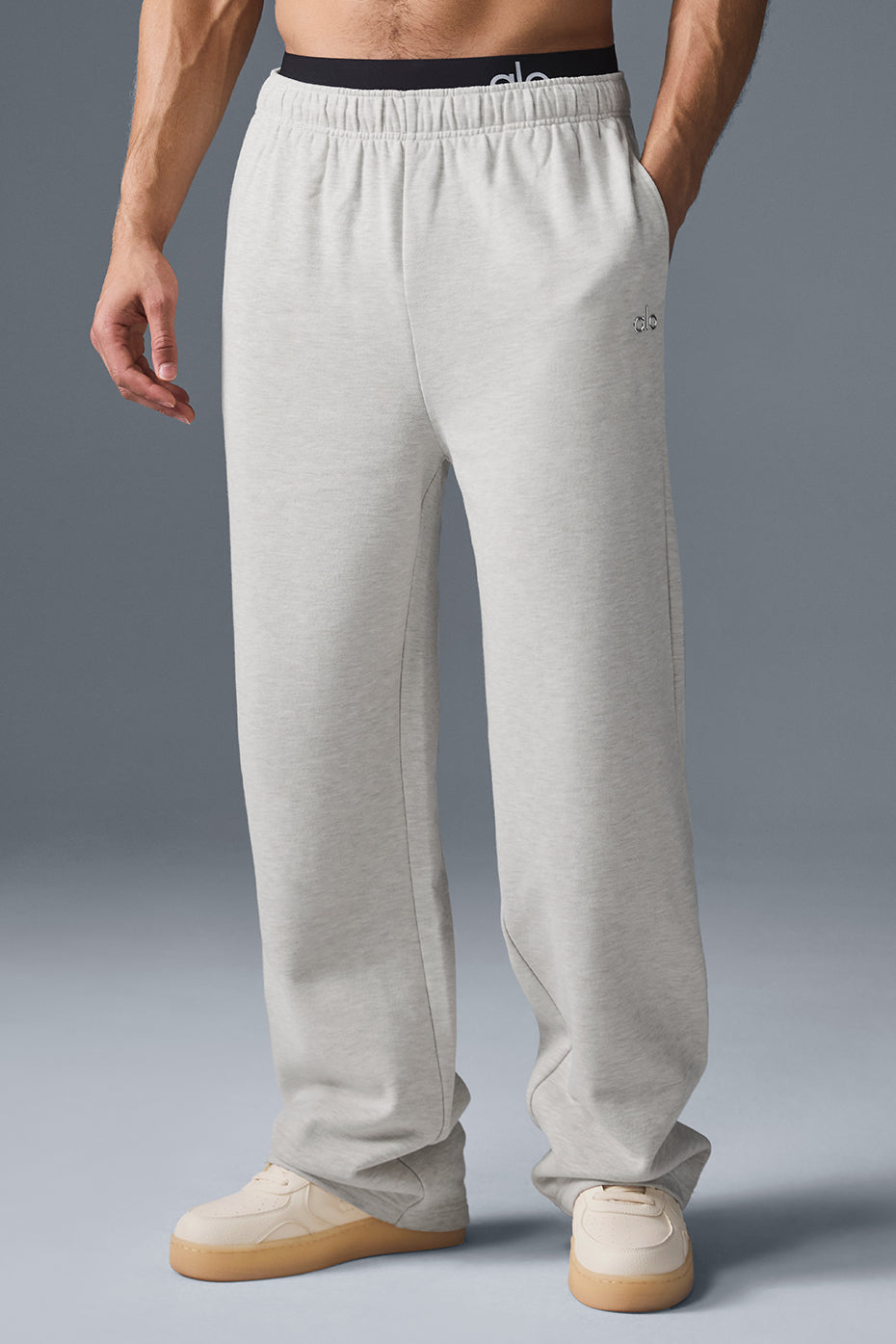 Close-up of the soft fabric and chrome logo detail on the white Heather sweatpants
