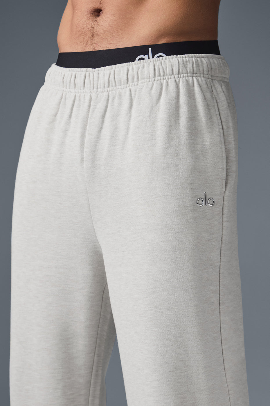 Model styling wide leg sweatpants with a bold jacket for outdoor activity
