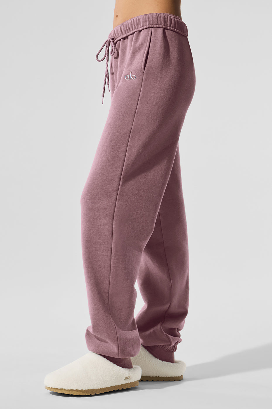 Model wearing grey sweatpants with a matching hoodie for an athleisure outfit.