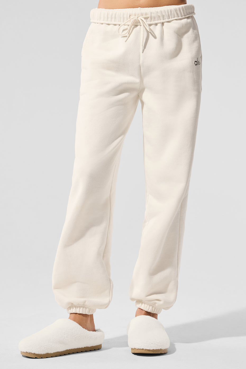 Front view of ivory baggy sweatpants styled for casual loungewear.