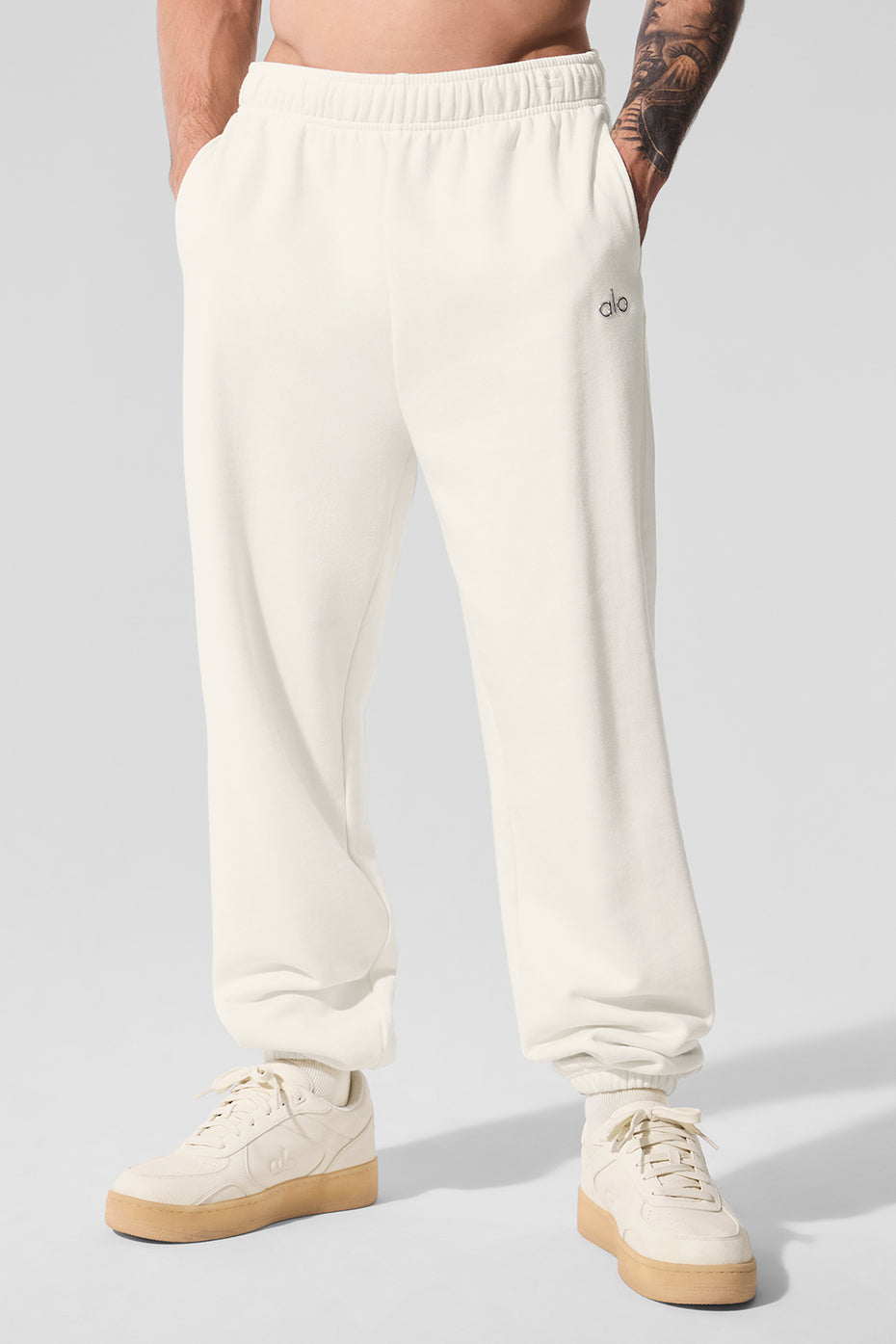 Front view of ivory unisex sweatpants with relaxed fit and elastic waistband
