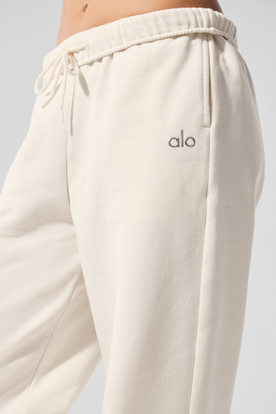 Front view of ivory baggy sweatpants styled for casual loungewear.