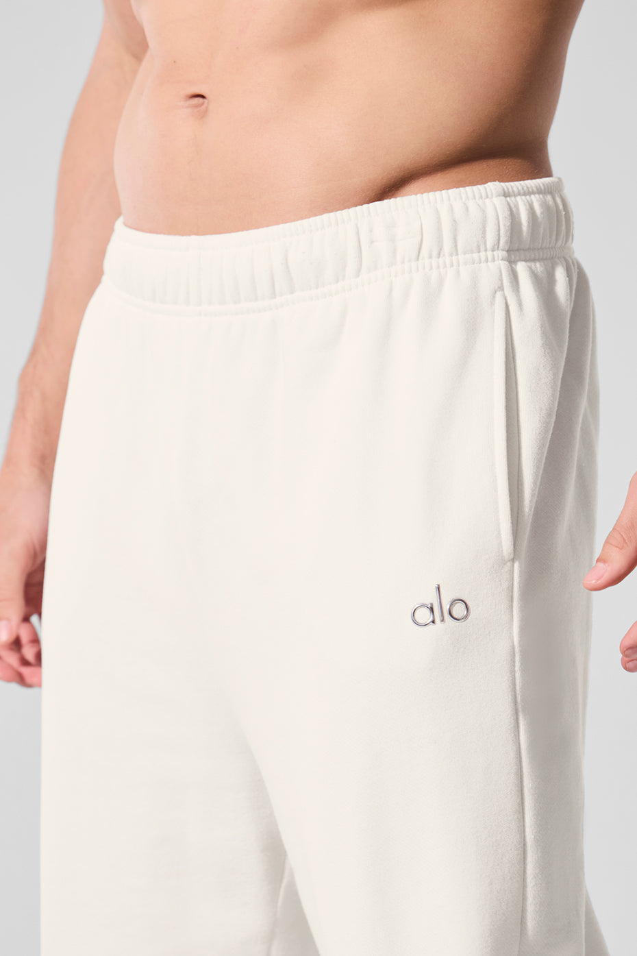 Front view of ivory unisex sweatpants with relaxed fit and elastic waistband