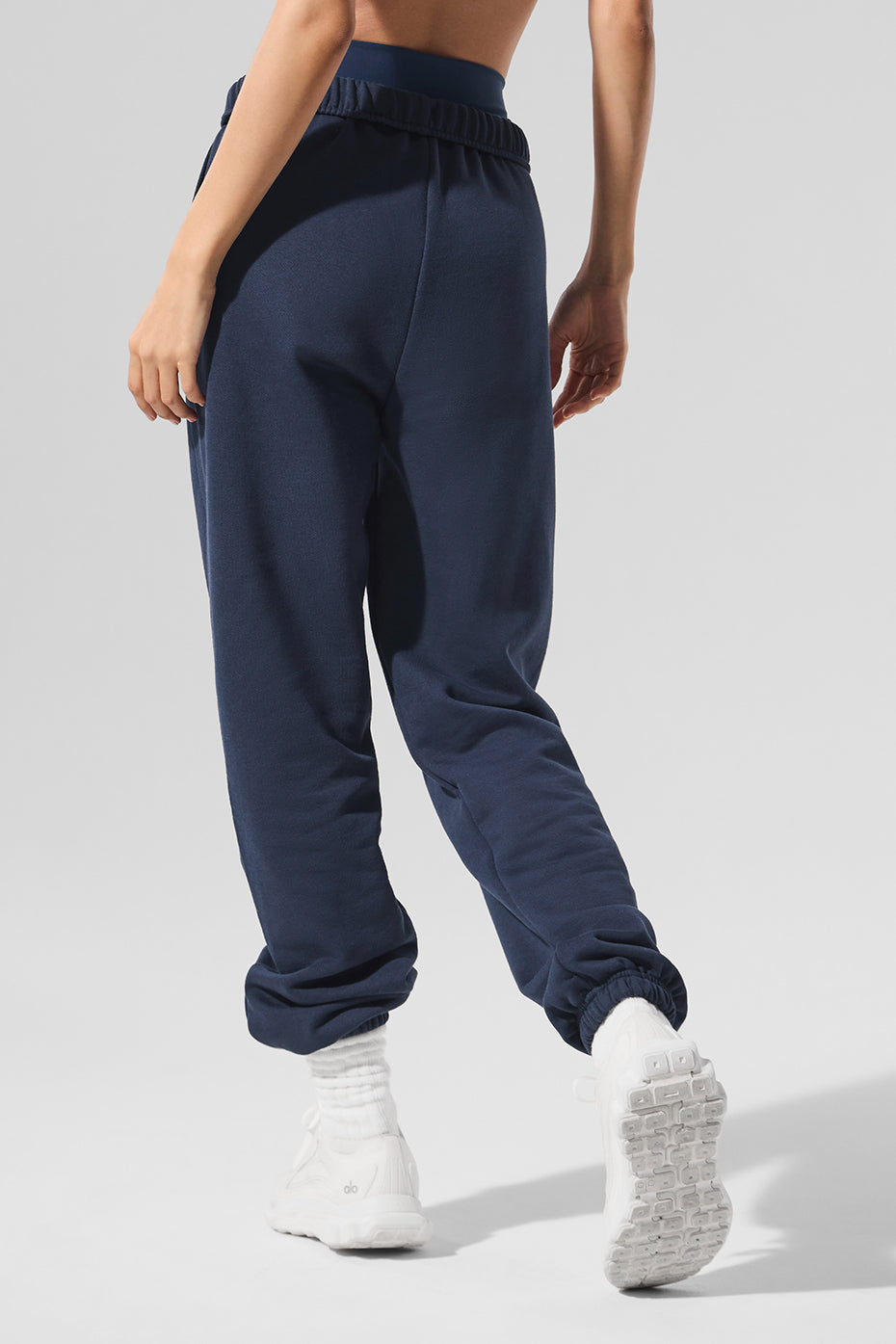 Front view of navy blue unisex sweatpants with elastic waistband and cuffs