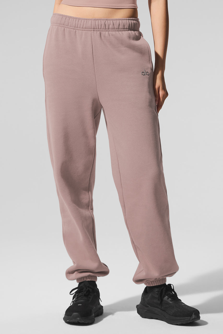 Close-up of waistband and cuffs on taupe sweatpants showing French terry texture.