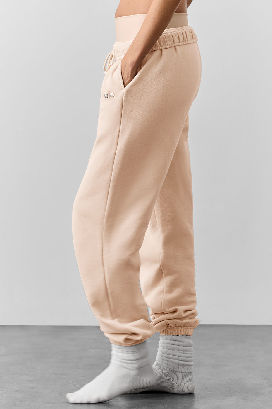 Front view of French terry pants in Macadamia color, relaxed fit with elastic waistband