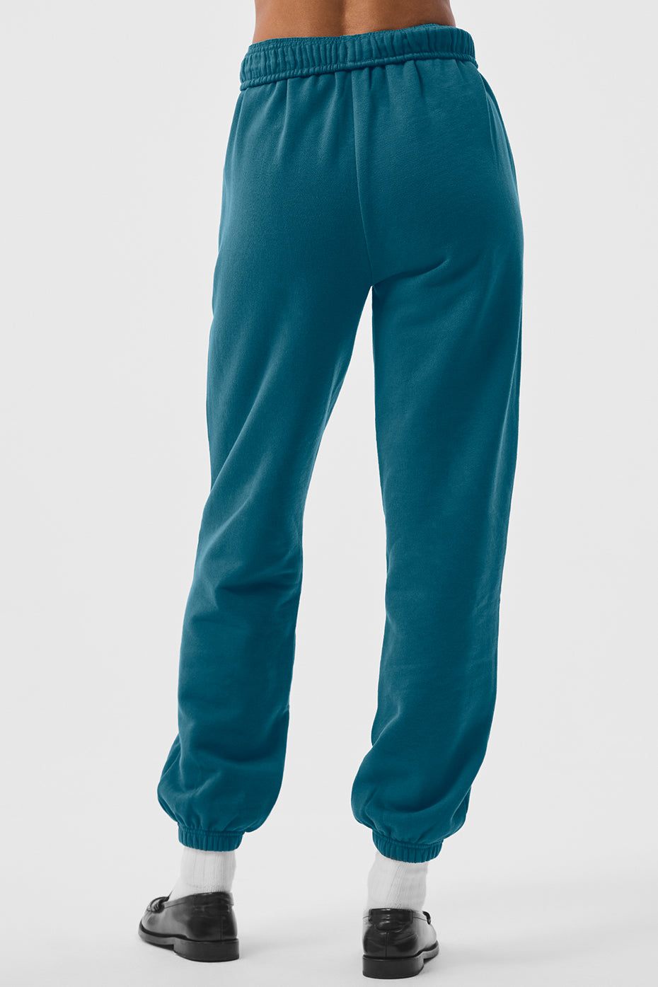 Sweatpants for short men folded on a wooden bench