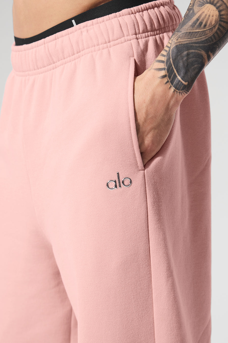 Side view of relaxed fit camo sweatpants in a casual setting.