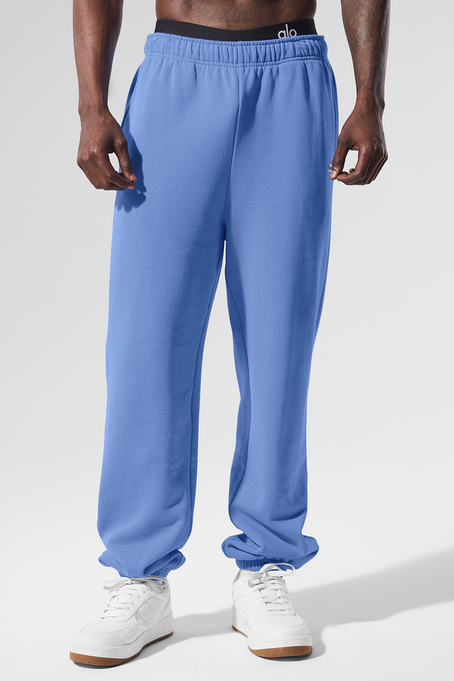 Close-up of blue wide leg sweatpants with elastic waistband and cuffs