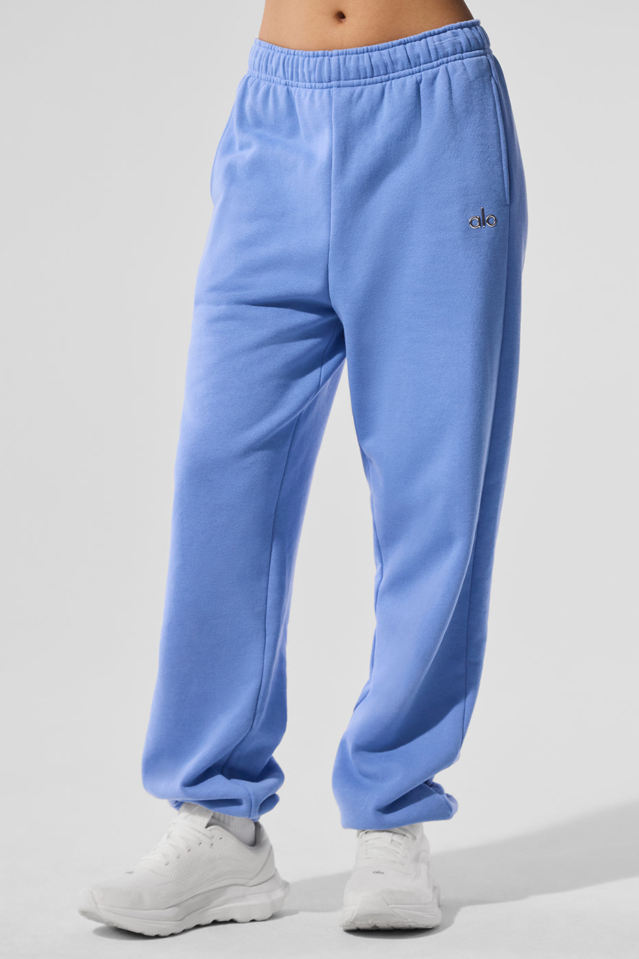 Model lounging in Accolade wide leg sweatpants paired with a hoodie, ideal for athleisure wear.