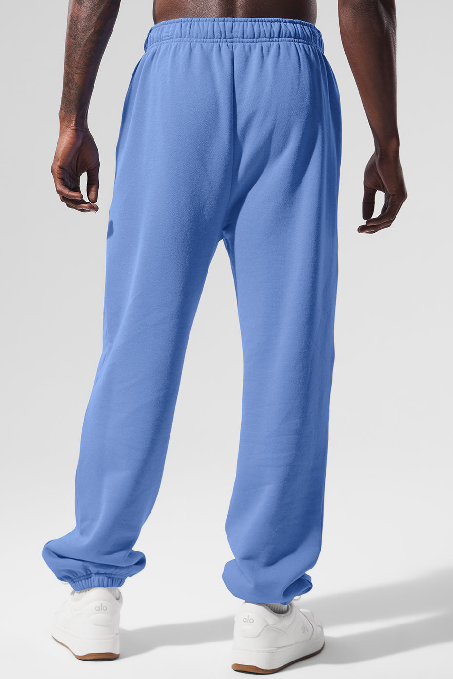 Model wearing relaxed fit sweatpants paired with a casual hoodie outdoors