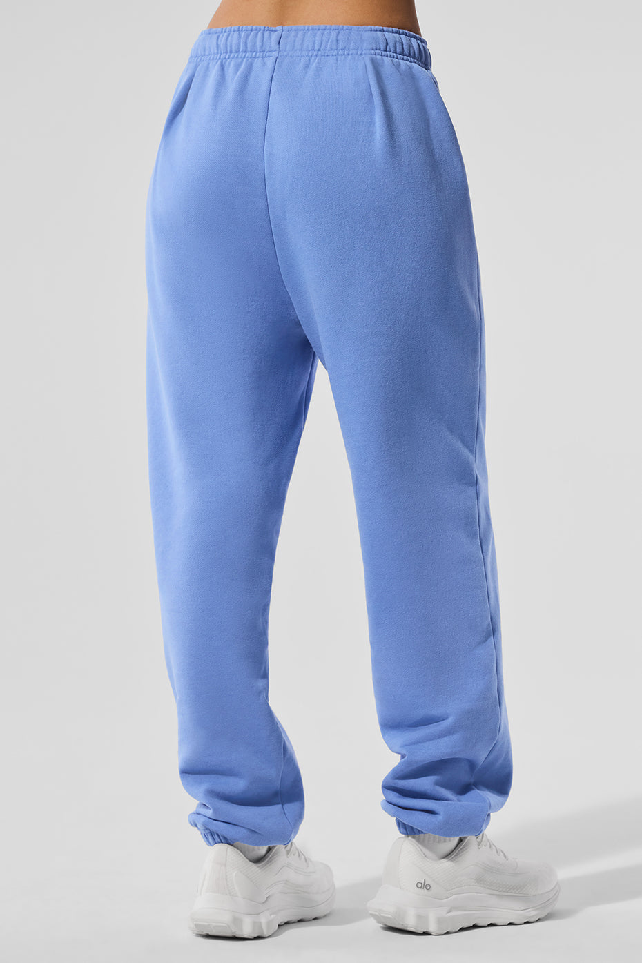 Accolade black sweatpants displayed on a hanger, highlighting the relaxed fit and cuffs.