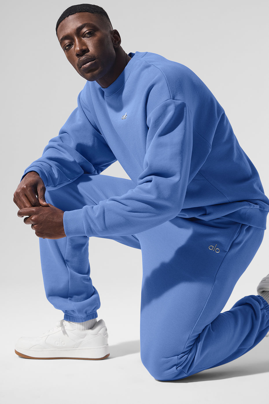 Close-up of blue wide leg sweatpants with elastic waistband and cuffs