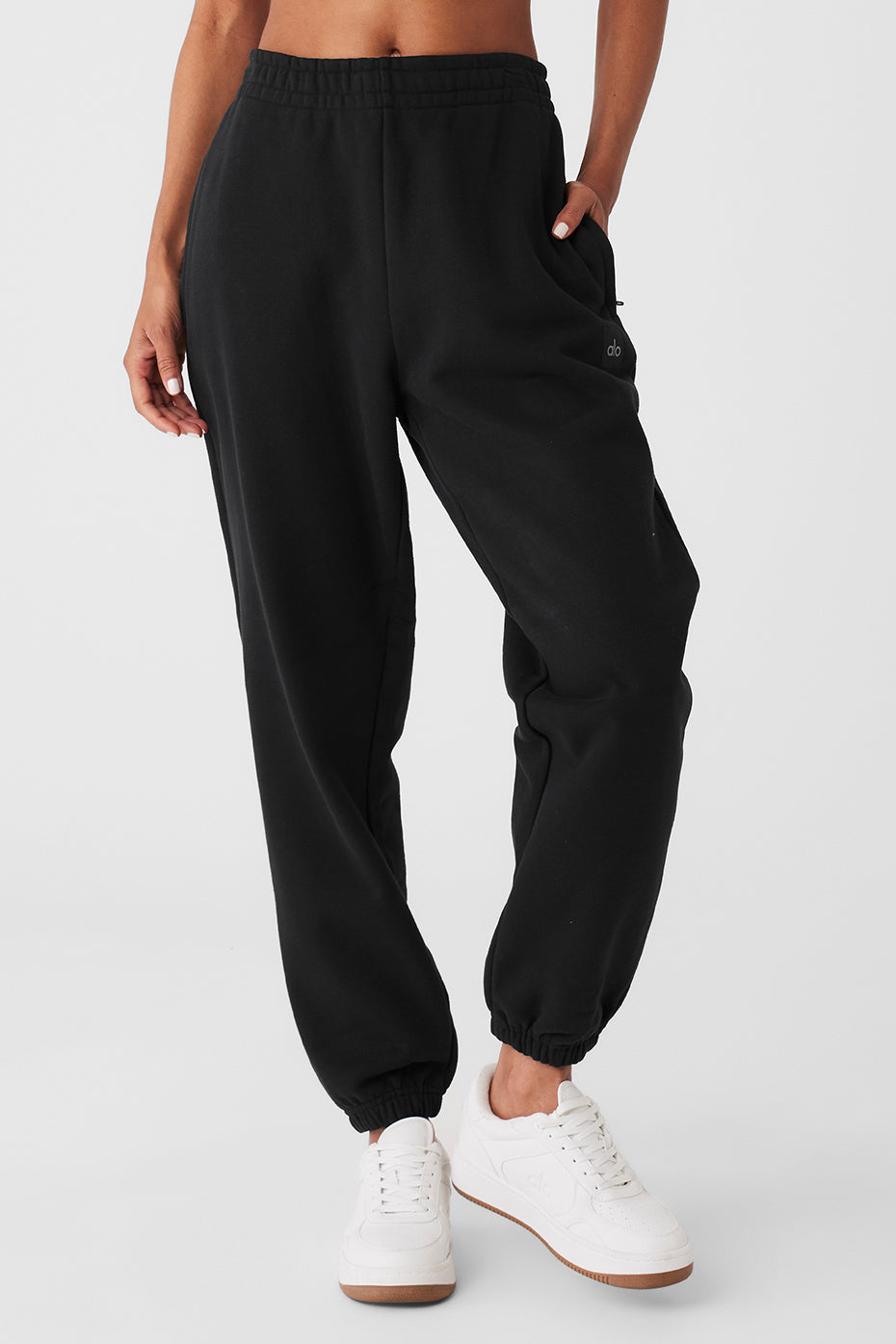 Back view of men's cuffed sweatpants styled with Renown hoodie in a city crosswalk