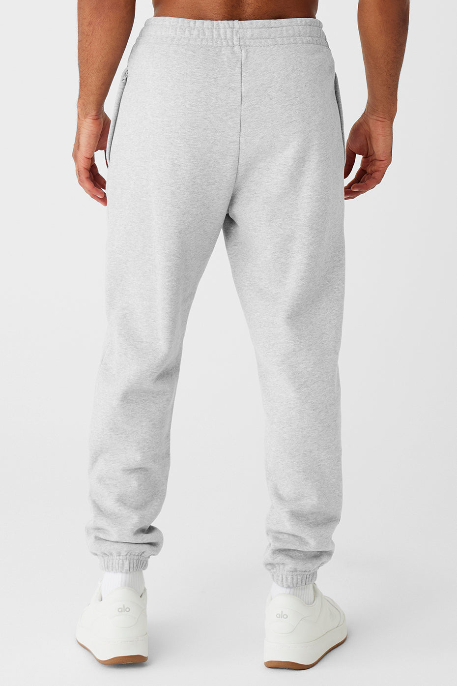 Close-up of zip-up side pockets on cuffed sweatpants, designed for convenience.