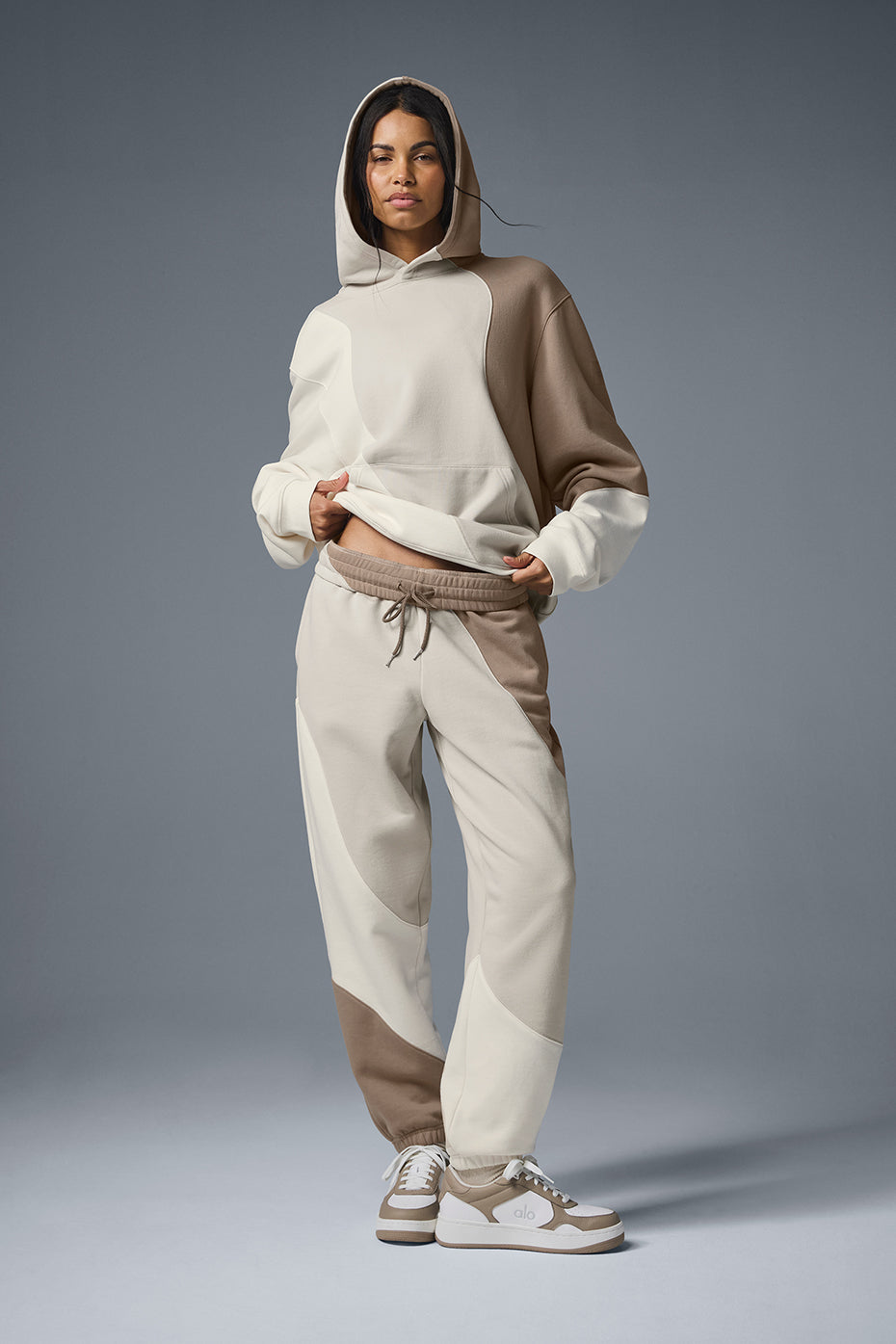 Model wearing ivory wave stitch sweatpants with oversized hoodie