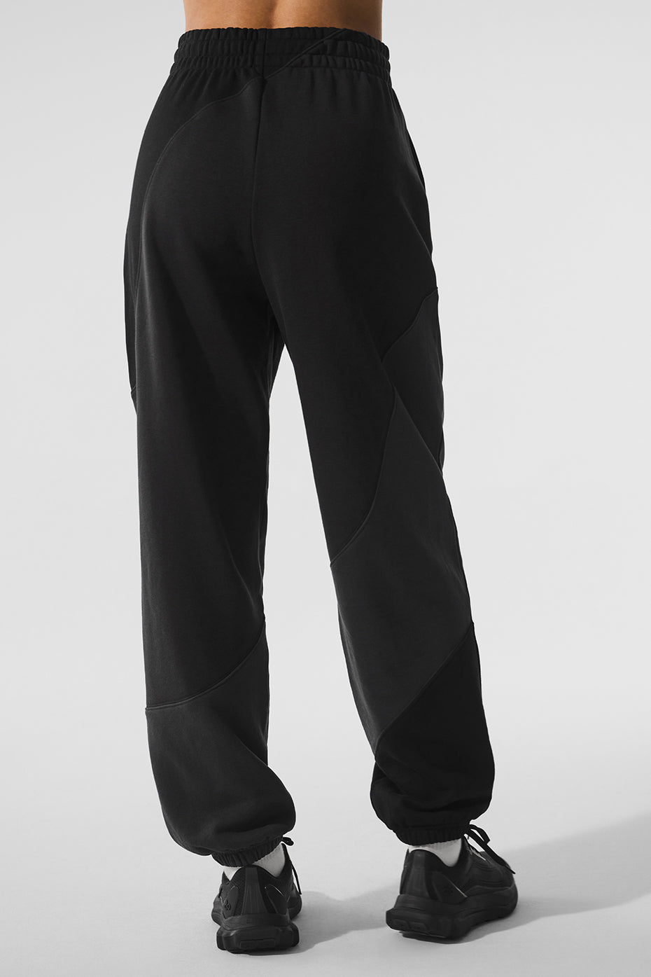 Close-up of the wave pattern on vintage black sweatpants, showing detailed seaming