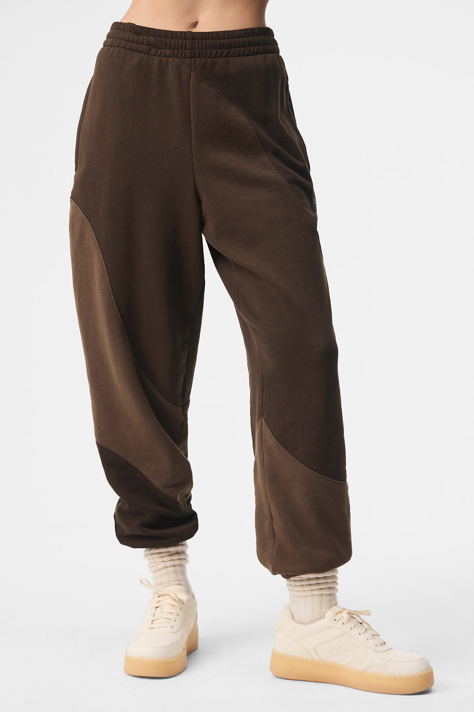 Front view of espresso baggy sweatpants styled for city errands
