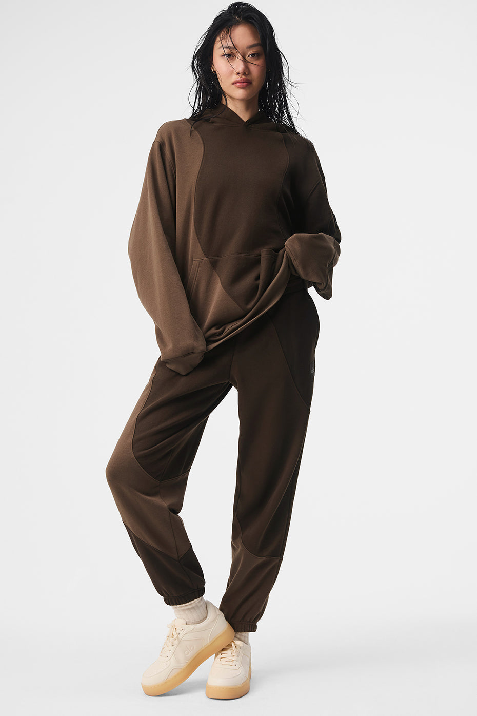 Front view of espresso baggy sweatpants styled for city errands