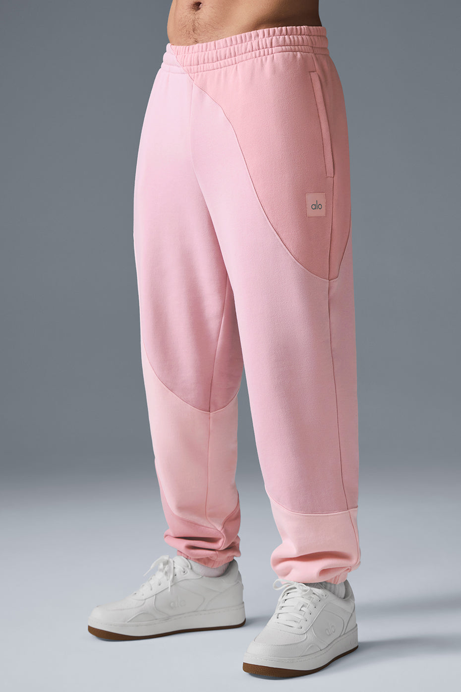 Model wearing relaxed-fit camo sweatpants with elastic cuffs