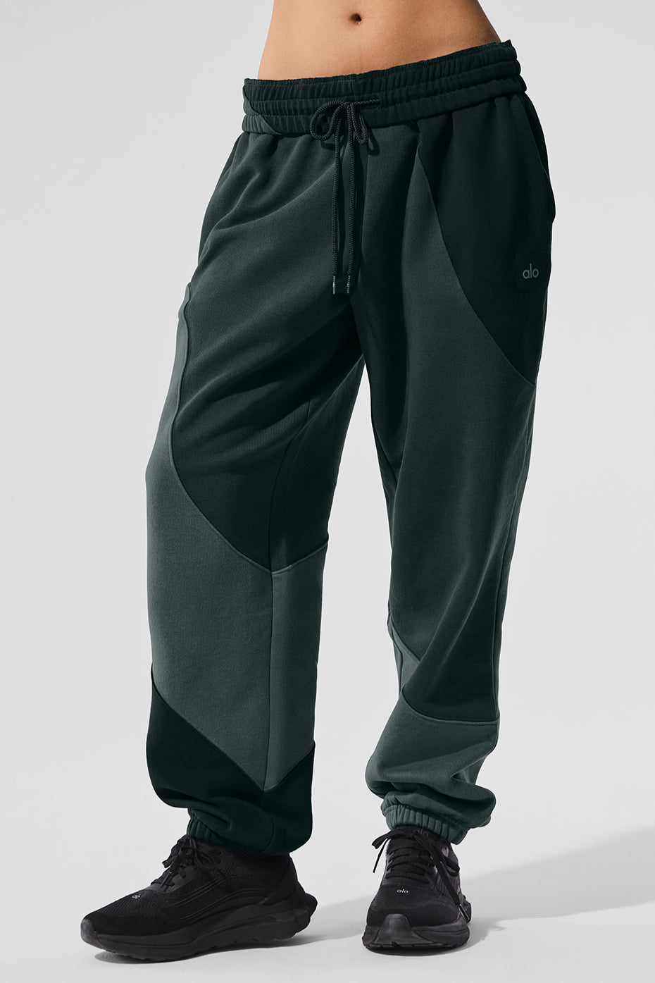 Side view of model wearing charcoal grey sweatpants with wave detailing