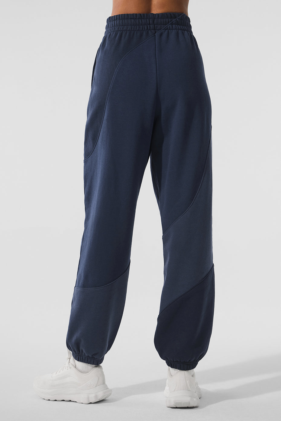 Model wearing navy sweatpants paired with a cropped top