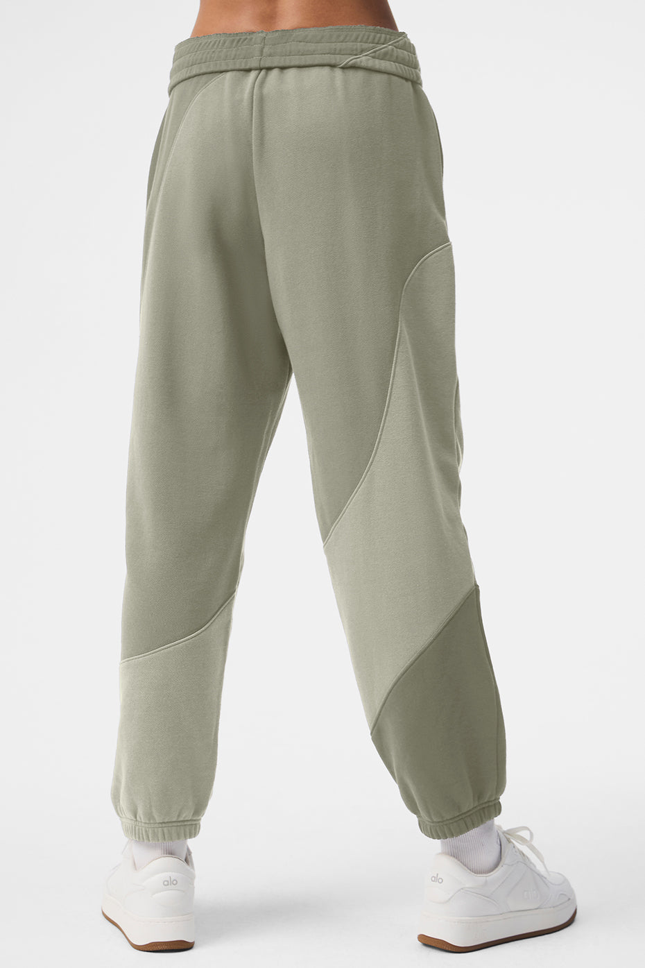 Male model showcasing relaxed fit of wide-leg camo sweatpants