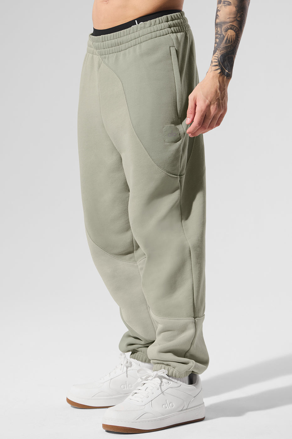 Model wearing baggy sweatpants with stitched wave pattern and matching hoodie